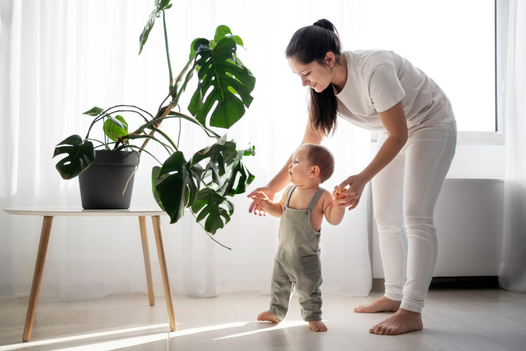 curious child looking at a houseplant